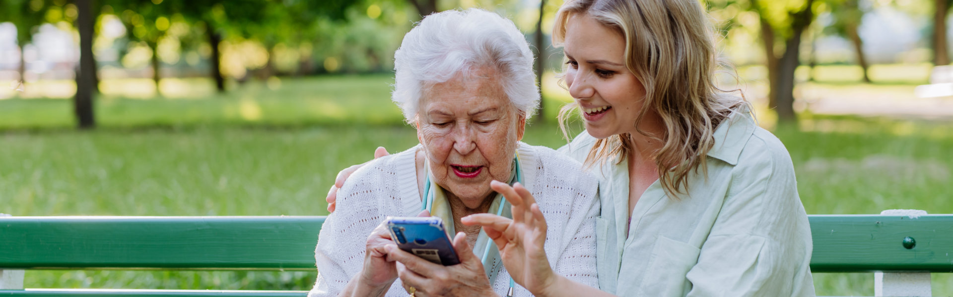 elderly and caregiver using cellphone
